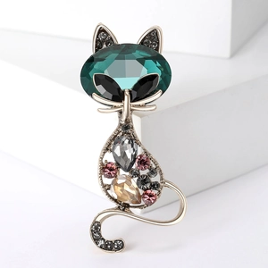 Detail of vintage cat brooch featuring emerald-cut crystal and colorful rhinestones