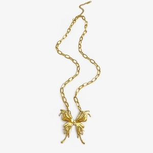 Statement gold butterfly pendant necklace with textured metallic finish on white background
