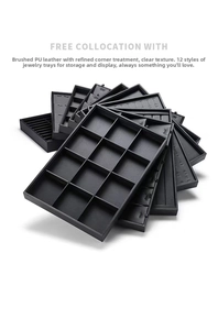 Detail view of 12 distinct black brushed PU leather jewelry display trays for rings