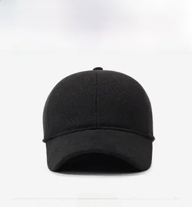 Close-up of black winter baseball cap featuring a silver metal shield buckle with FASHION text