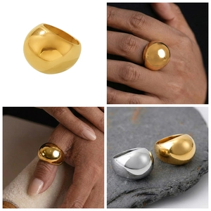 Macro detail of high-polished dome rings in 18k gold and silver stainless steel