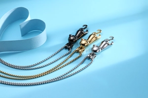 Detailed view of three cute cat pendant necklaces in black gold and silver stainless steel