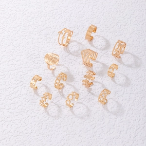 Detail view of 12-piece gold ear cuff set featuring star, moon, leaf and evil eye designs
