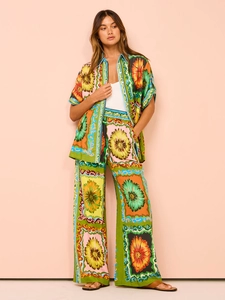 Detail of floral two-piece set featuring short-sleeve shirt and wide-leg trousers