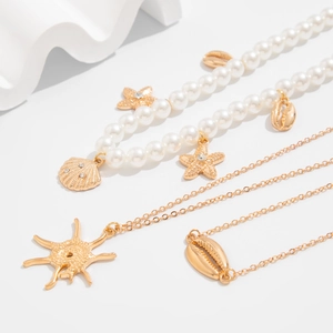 Three-piece ocean style layered necklace with faux pearls, gold starfish and shell pendants