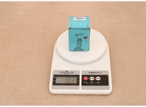 Detailed view of Santa crystal ball packaging on scale showing total weight of 103g
