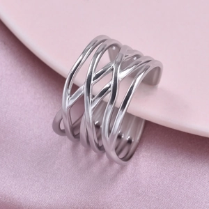 Detail of silver multi-layer woven wide ring in stainless steel on pink silk background
