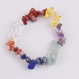 Detailed top view of natural colorful crystal stone bracelet on a clean white background