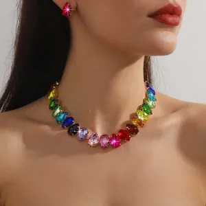 Detail of colorful waterdrop crystal necklace and earring set on a female model