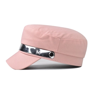 Detail of pink cotton newsboy cap with silver metallic band and engraved M buckle decoration