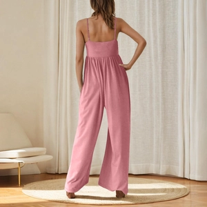Detail of pink sleeveless jumpsuit featuring an open back design and wide leg cut