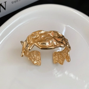 Detail of gold-plated adjustable ring featuring irregular molten lava wrinkle texture