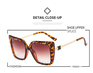 Detail of tortoise frame butterfly sunglasses with gold temples and gradient lenses