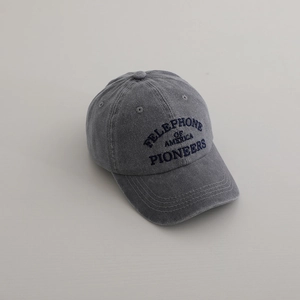 Macro view of washed denim baseball cap with vintage embroidery and reinforced stitching