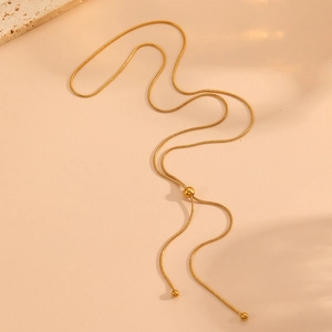 Detail of adjustable 18k gold plated snake chain with sliding bead and tassel design