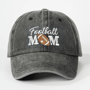 Detail view of the intricate Football MOM embroidery on a washed dark gray cotton baseball cap