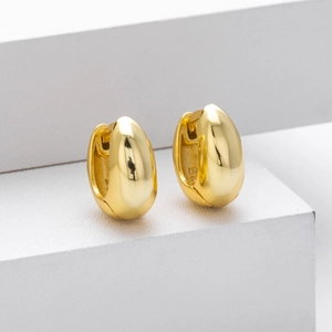 Detailed macro view of smooth golden water-drop shaped S925 sterling silver hoop earrings