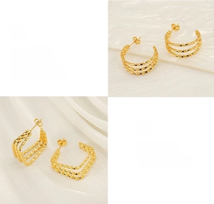 Detailed macro view of polished gold finish and layered geometric texture on earrings