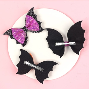 Detailed view of Halloween glitter purple bat wing hair clips with metal duckbill clips