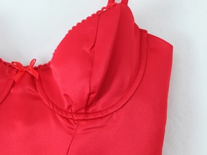 Detail of red satin bustier bodice with underwire support and central bow detail