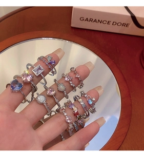 Detail shot of colorful zircon rings featuring heart and star shapes in silver finish