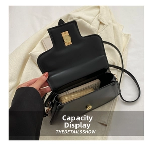 Interior view of black leather saddle bag showing capacity for phone and wallet