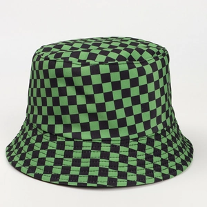 Detail of green and black checkered reversible bucket hat with high quality fabric texture