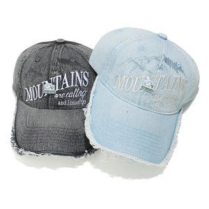 Washed denim baseball cap with mountains letter embroidery and frayed edge detail