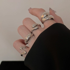 Close-up of liquid metal style silver rings with high-polish finish on a hand