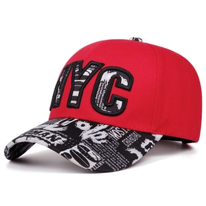 Detail of red NYC snapback cap with retro newspaper print embroidery and flat brim style