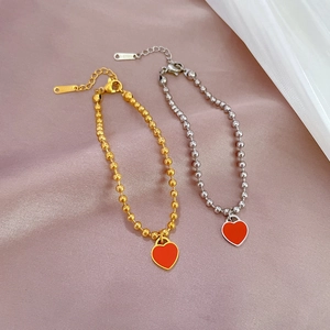 Titanium steel heart pendant beaded bracelets in gold and silver with red enamel charm