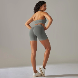 Detail of grey-green seamless yoga set showing ribbed texture and high-waist fit on model