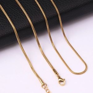 Close-up of golden stainless steel snake chain with lobster clasp and extender