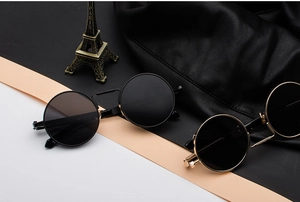 Detail of round steampunk sunglasses with metal spring temples and vintage black frames