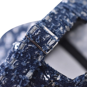 Detailed macro view of denim baseball cap with silver sequins and metal buckle strap