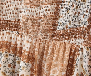 Detail of vintage paisley print in brown and beige with elastic pleated waist texture