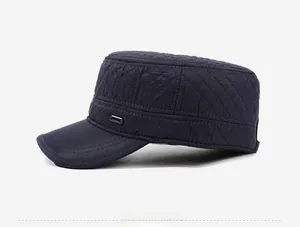 Detailed side view of navy quilted flat top cap with fleece lining and metal accent