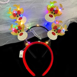 Detail of Christmas headband with gold glitter antlers, LED lights and battery box control