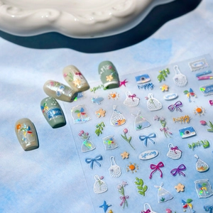 Laser cartoon nail stickers with floral and butterfly patterns on blue water background