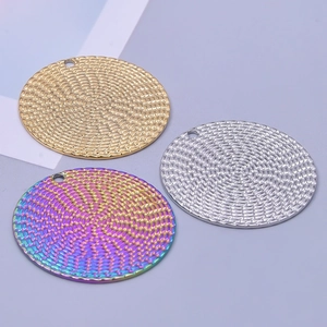 Macro detail of round woven texture metal pendants in gold, silver and rainbow colors