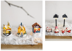 Detail of light-up Christmas candy store cabin with miniature Santa and snowman figures