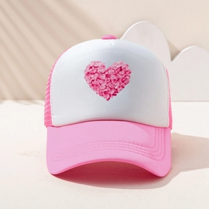 Close-up of pink floral heart print on a white mesh trucker hat for a sweet look