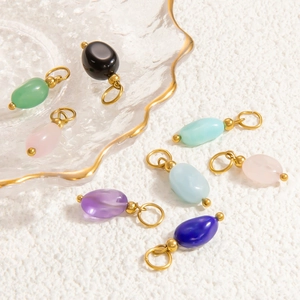 Mix of colorful oval natural stone pendants with golden metal loops for jewelry making