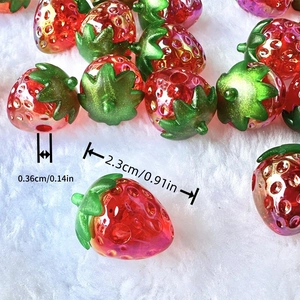 3D acrylic strawberry beads with size markers on soft white fur background