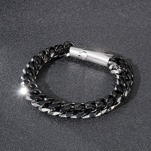 Close-up of a dual-tone silver and black stainless steel Cuban chain bracelet for men