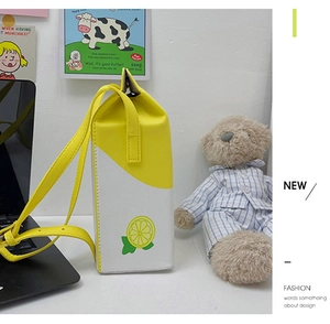 Close-up of lemon milk box crossbody bag with yellow print and adjustable strap