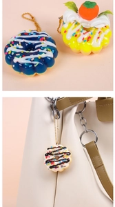 Close-up of artificial doughnut keychains with cream coating and colorful sprinkles