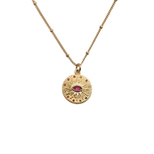 Detail of gold evil eye pendant necklace with red crystal and colorful gemstones