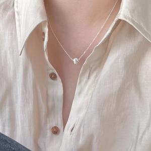 Minimalist 925 sterling silver bead pendant necklace worn on neck with linen shirt