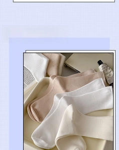 Close-up of soft ribbed knit cotton socks in earthy tones on a decorative tray